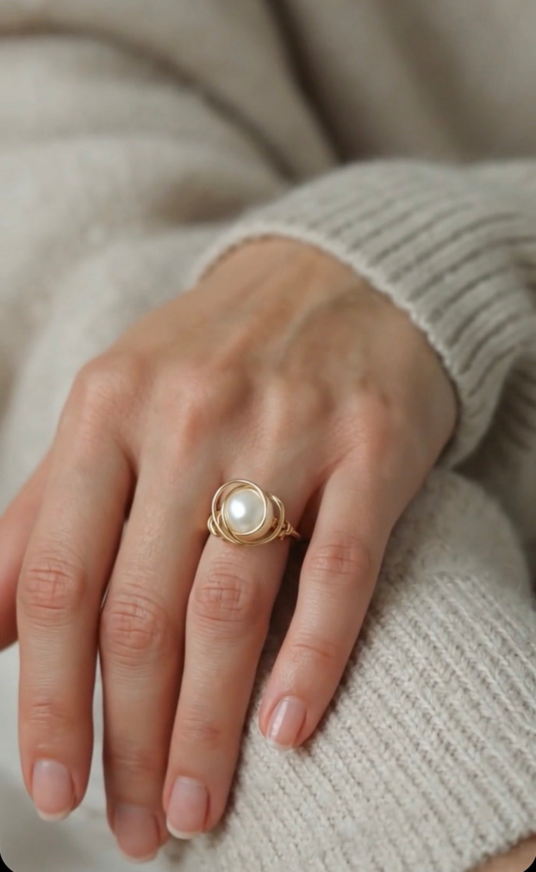 Elegant handmade 14k gold filled ring with a white pearl worn on a model's hand, demonstrating daily jewelry style.